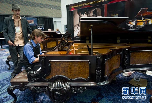 1月21日，观展者正在试弹中国手工钢琴  